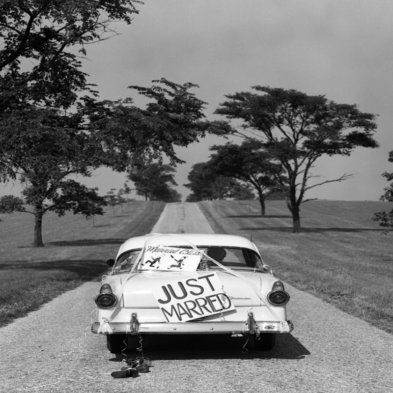 Holy Mackerel just married retro black and white photographic card featuring a vintage image of a wedding couple in a classic American car - 12.6 x 17.7cm and blank inside
