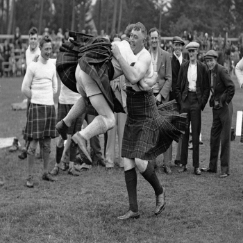 Holy Mackerel swirling kilts retro black and white photographic card featuring a vintage image of wrestling at the Highland games - 12.6 x 17.7cm and blank inside