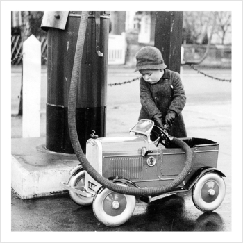 Holy Mackerel filling up with petrol retro black and white photographic card featuring a vintage image of a child with a toy car - 15cm square and blank inside