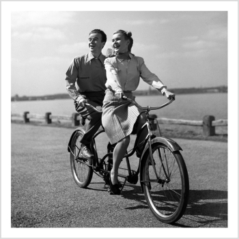 Holy Mackerel couple on a bike retro black and white photographic card featuring a vintage image of a man and woman on their tandem - 15cm square and blank inside