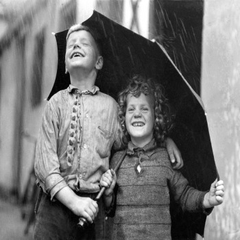 Holy Mackerel taking cover retro black and white photographic card featuring a vintage image of laughing children sharing an umbrella in the rain - 12.6 x 17.7cm and blank inside