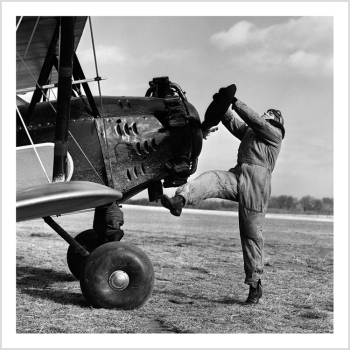 Holy Mackerel Pilot retro black and white photographic card featuring a vintage image of an aviator turning the propellor to start his plane - 15cm square and blank inside