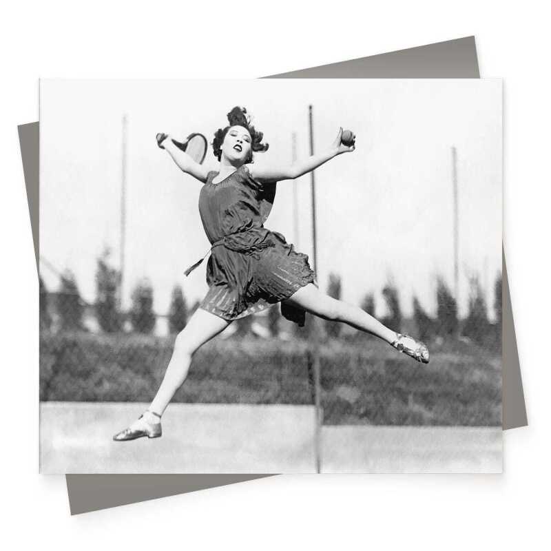 Flying return, black & white vintage photographic card featuring a tennis player mid leap - 12.6 x 17.7cm and blank inside - made in the UK
