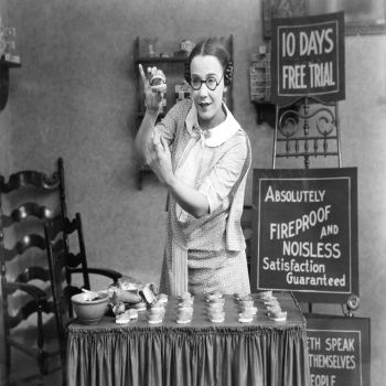 Holy Mackerel gnashers on display retro black and white photographic card featuring a vintage image of a false teeth saleswoman - 12.6 x 17.7cm and blank inside