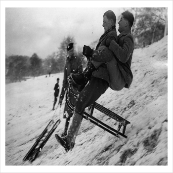 Young men on a sledge on Hampstead Heath, London, a 127 x 175mm Alternative Image winter themed Christmas card featuring a vintage black and white photo, message inside says Happy Christmas