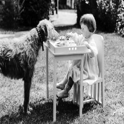 Holy Mackerel sharing a meal retro black and white photographic card featuring a vintage image of a little girl and her dog - 12.6 x 17.7cm and blank inside