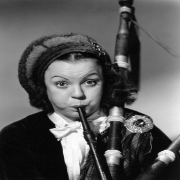 Holy Mackerel blowing a tune retro black and white photographic card featuring a vintage image of a woman with a set of Scottish bagpipes - 12.6 x 17.7cm and blank inside