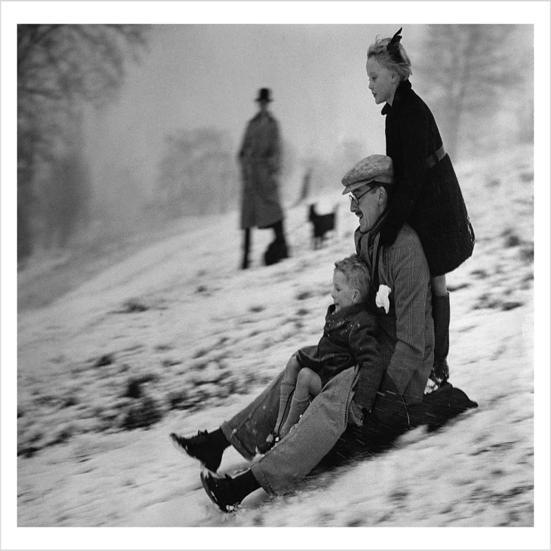 Family tobogganing on Hampstead Heath, London, a 127 x 175mm Alternative Image winter themed Christmas card featuring a vintage black and white photo, message inside says Happy Christmas