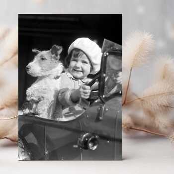 Little girl and dog in toy car - vintage black and white themed card - 12.6 x 17.7cm and blank inside - made in the UK