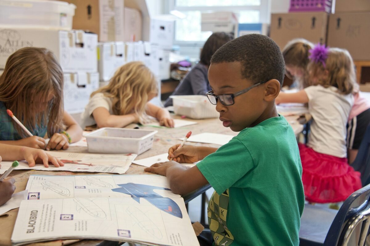 A therapist working one-to-one with a child in a school setting