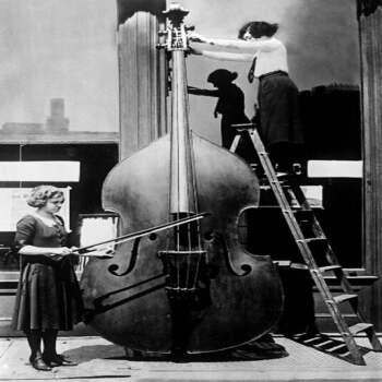 Holy Mackerel enormous cello retro black and white photographic card featuring a vintage image of a giant instrument - 12.6 x 17.7cm and blank inside