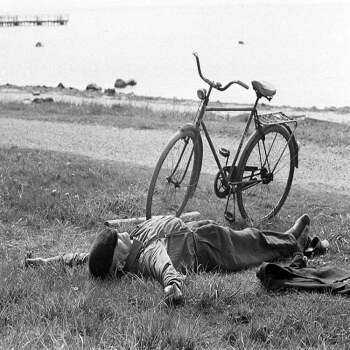 Man sleeping beside bike