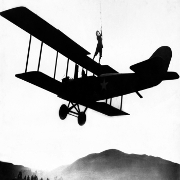 Holy Mackerel stuntwoman retro black and white photographic card featuring a vintage image of a wingwalker performing a stunt on a biplane - 12.6 x 17.7cm and blank inside
