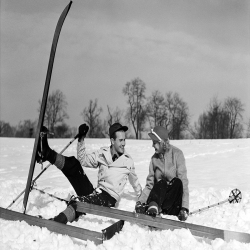 Couple Sitting in Snow with skis - a 17.5 x 12.5cm Christmas Card from Holy Mackerel's Alternative Image Range of Festive Designs.