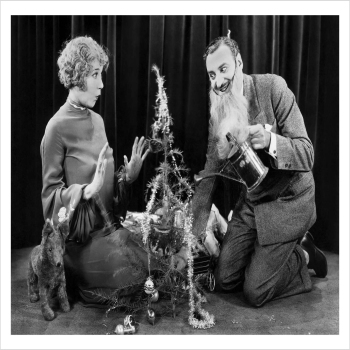 Watering the Christmas tree, a 127 x 175mm Alternative Image Christmas card featuring a vintage black and white photo of Hollywood actors, message inside says "Happy Christmas"