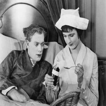 Holy Mackerel take your medicine retro black and white photographic card featuring a vintage image of a nurse treating a patient - 12.6 x 17.7cm and blank inside