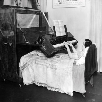 Holy Mackerel piano playing in bed retro black and white photographic card featuring a vintage image of an instrument devised for anyone bedridden - 12.6 x 17.7cm and blank inside
